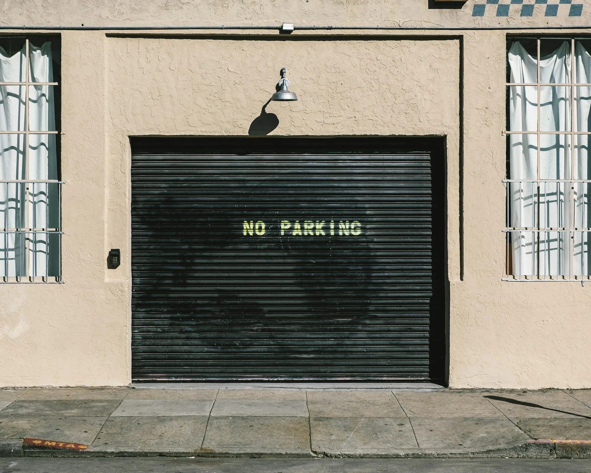 Black metal roll-up door on a commercial building